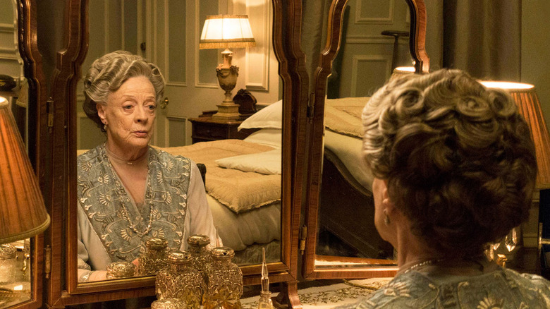 Dame Maggie Smith looking at herself in a mirror in Downton Abbey 