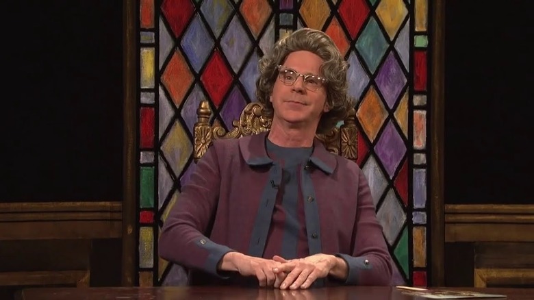 Dana Carvey sitting at desk Saturday Night Live