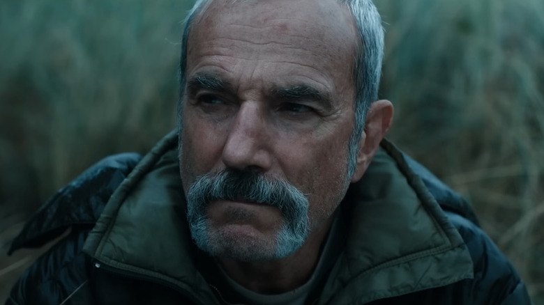 Daniel Day Lewis as Ray sitting in a field in Anemone