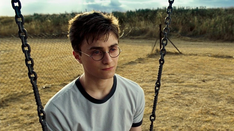 Daniel Radcliffe in the role of Harry Potter sitting on a hugging in Harry Potter and Phoenix ranking