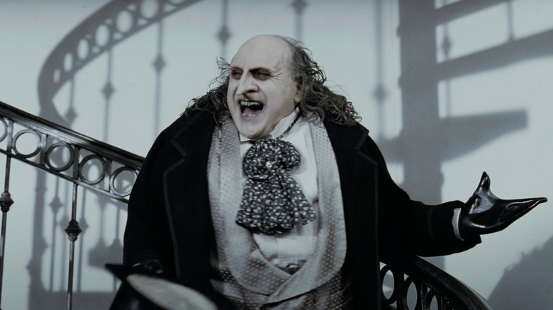 Danny DeVito's Penguin addresses his staff from a staircase in Batman Returns