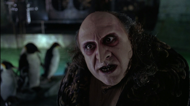 Danny DeVito's Oswald Cobblepot looms over his penguins in the sewers, in Batman Returns.