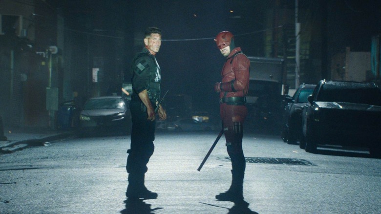 Jon Bernthal as The Punisher and Charlie Cox as Daredevil standing in a street at night in Daredevil: Born Again