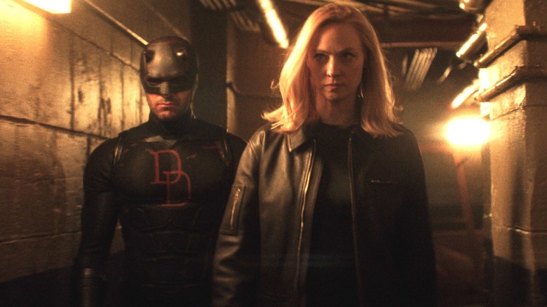 Daredevil: Born Again - Daredevil and Karen Page walking together in cellar hall