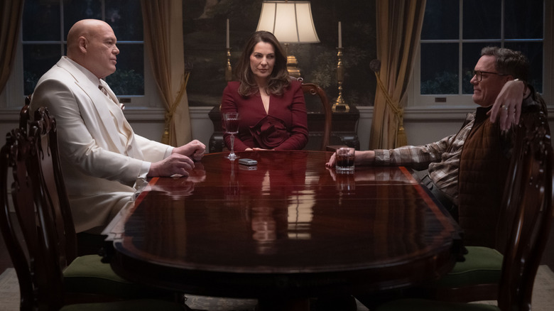 Vincent D'Onofrio as Wilson Fisk seated at a dinner table with Ayelet Zurer as Vanessa Fisk and Matthew Lillard as Mr. Charles in Daredevil: Born Again