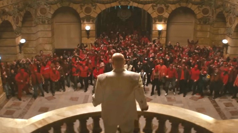Vincent D'Onofrio as Wilson Fisk standing on a balcony overlooking an angry mob of protestors in Daredevil: Born Again