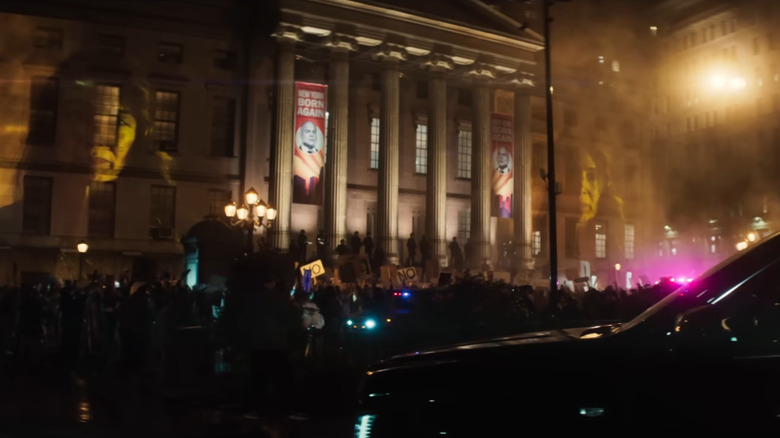 An establishing shot of a New York City courthouse surrounded by armed officers and a group of protestors in Daredevil: Born Again