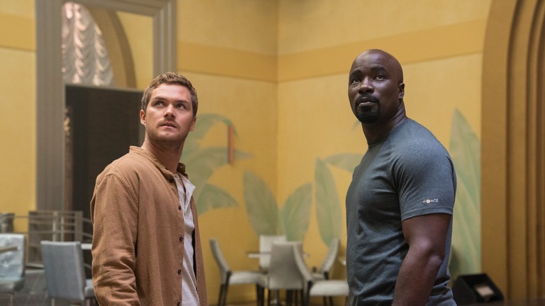 Finn Jones as Danny Rand and Mike Colter as Luke Cage in the "Luke Cage" episode, "The Main Ingredient"