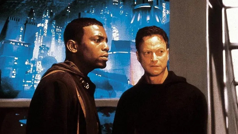 Cale and Olham near a sci-fi city-scape in Imposter