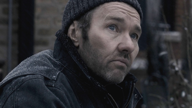 Joel Edgerton as Jason Dessen wearing a winter hat and coat covered in snow in Dark Matter