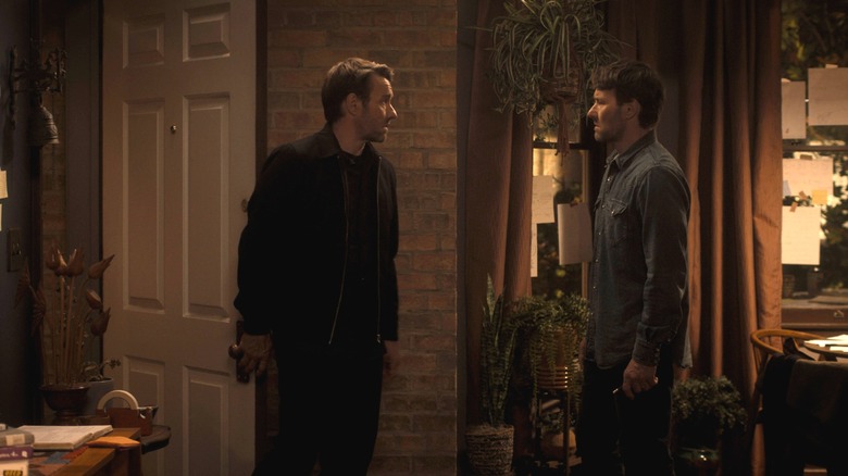 Joel Edgerton as Jason Dessen standing in a room opposite Joel Edgerton as "Jason2" in Dark Matter