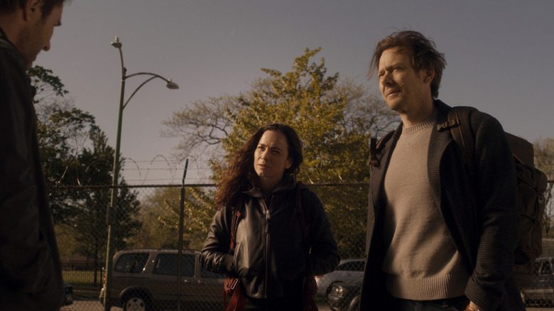 Joel Edgerton as Jason2 standing opposite Alice Braga as Amanda Lucas and Jimmi Simpson as Ryan Holder in a parking lot in Dark Matter