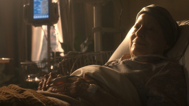 Linda Bove as Ellie Dessen laying in a hospital bed and smiling weakly in Dark Matter