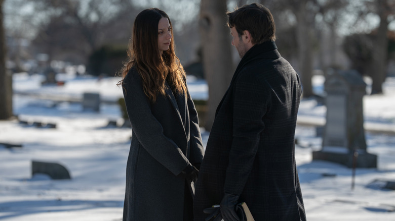 Joel Edgerton as Jason Dessen standing in a snowy cemetery opposite Angela Sarafyan as Maria in Dark Matter