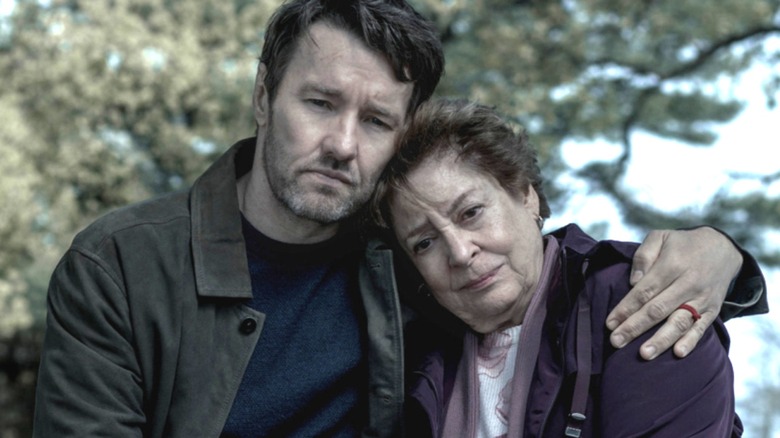 Joel Edgerton as Jason Dessen embracing Linda Bove as Ellie Dessen on a bench in a public park in Dark Matter