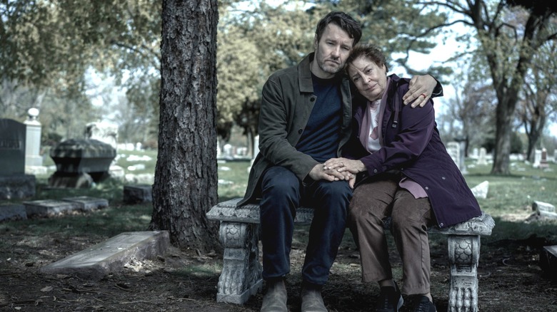 Joel Edgerton as Jason Dessen sitting on a park bench and embracing Linda Bove as Ellie Dessen in Dark Matter