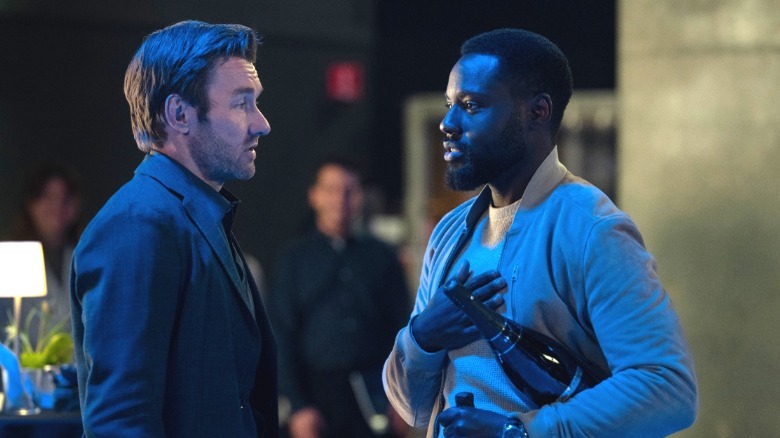 Jason Desson and Leighton Vance stand face to face at a fancy event in Dark Matter Season 2