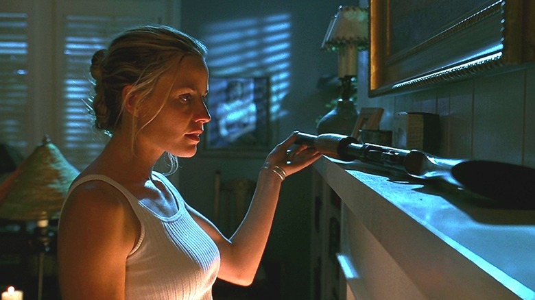 Annie looking at a shotgun in The Trigger Effect