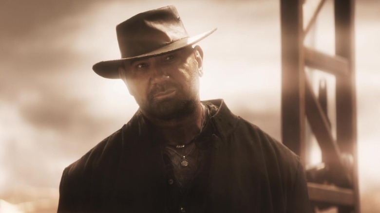 Dave Bautista as Boyce wearing a cowboy hat in In the Lost Lands