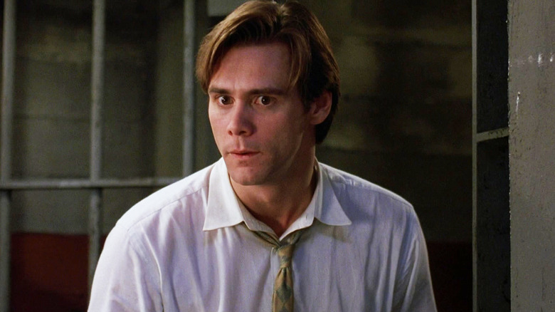 Jim Carrey's Stanley Ipkiss is seen standing in a jail cell in The Mask