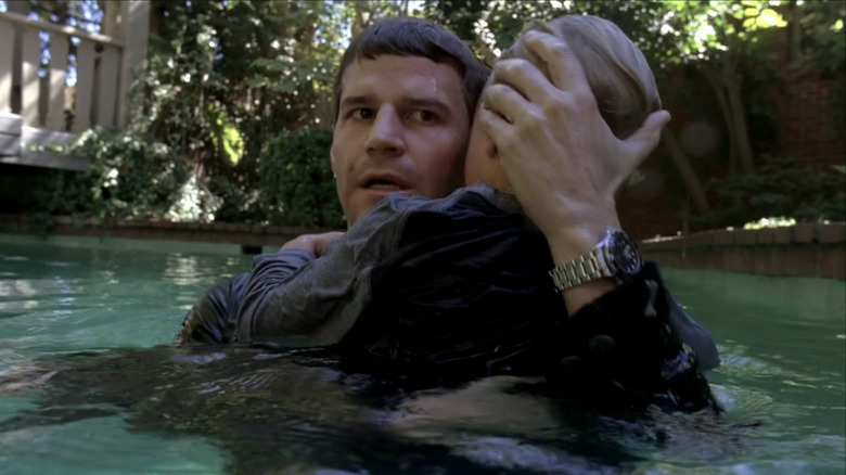 David Boreanaz's Seeley Booth holds a child in a swimming pool in Bones