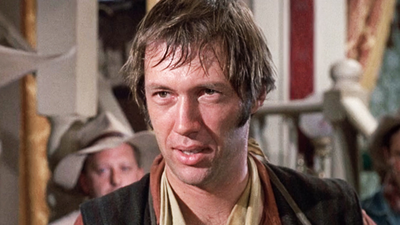 David Carradine's Jesse Boone is seen in closeup as he stands in a saloon in Young Billy Young
