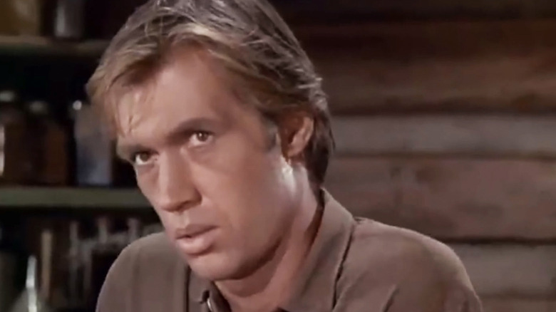 David Carradine's Shane looks up as he stands in a saloon in Shane