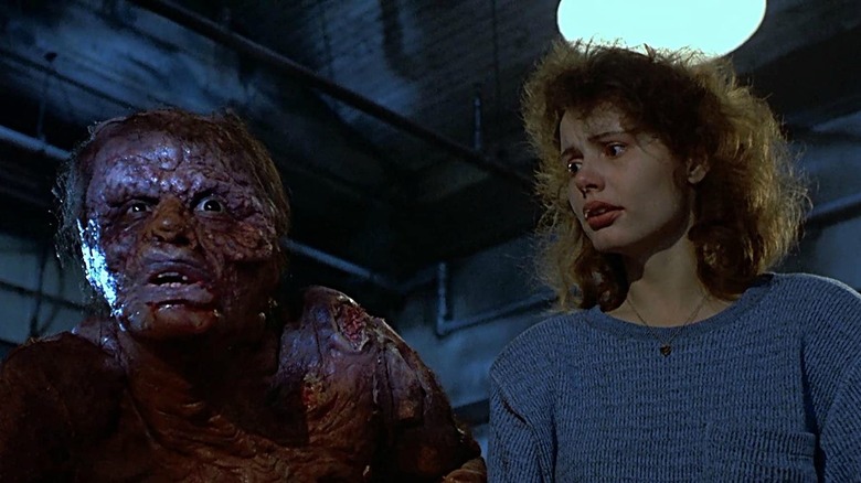 Geena Davis and the Brundlefly in The Fly.