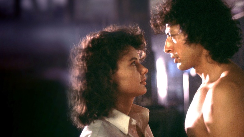 Jeff Goldblum and Geena Davis look at each other in The Fly