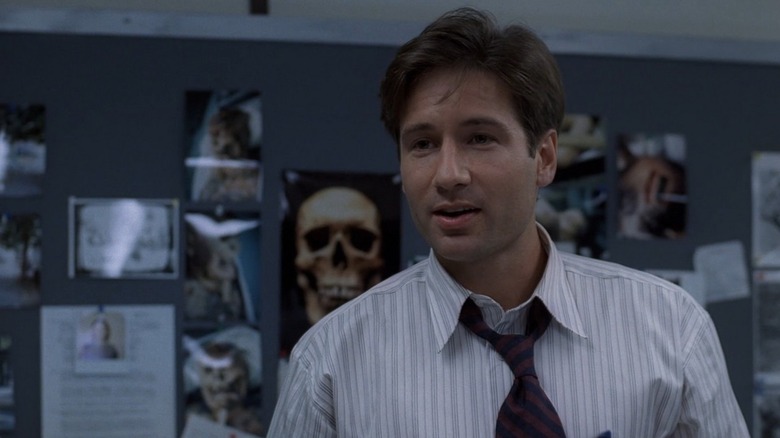 Fox Mulder with creepy posters in his office on The X-Files