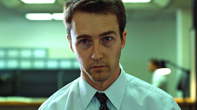 Edward Norton as the Narrator/Jack in Fight Club looking bored in his office