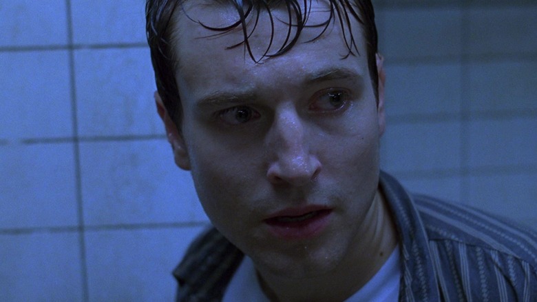 Lee Whannell as Adam looking sad in Saw