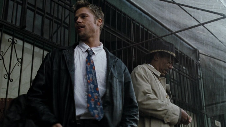 Brad Pitt as David Mills and Morgan Freeman as William Somerset stand in the rain in Se7en