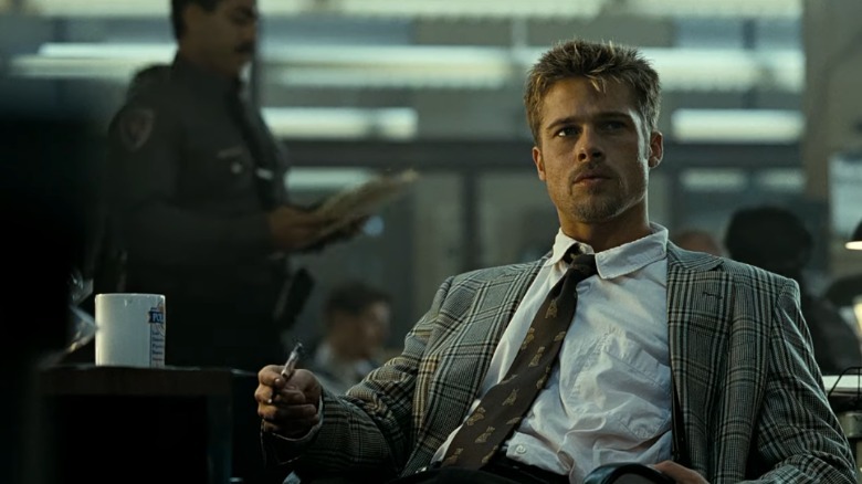 Brad Pitt sitting at a desk