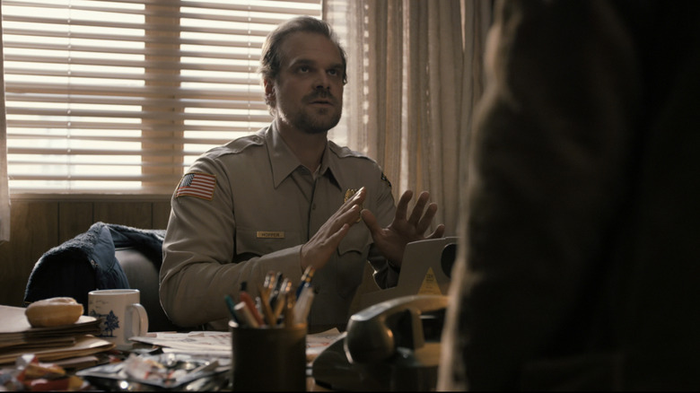 David Harbours Jim Hopper looks up as he sits at his desk in "Stranger Things"