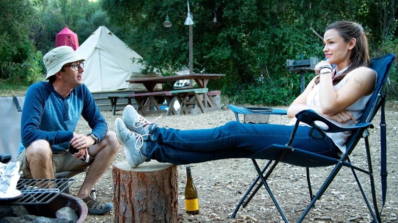 Walt looking at a recliing Kathryn in Camping