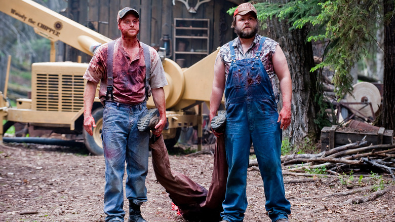 Alan Tudyk's Tucker and Tyler Labine's Dale dragging a body in Tucker and Dale vs. Evil