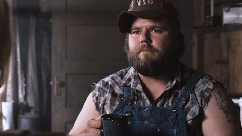 Tyler Labine's Dale drinking a cup of coffee in Tucker and Dale vs. Evil