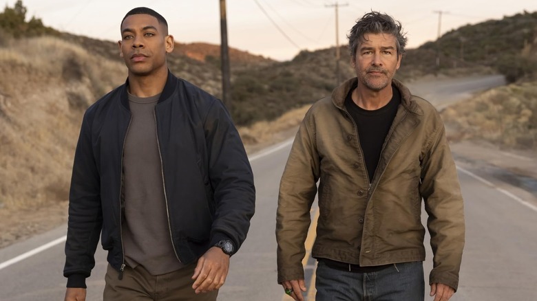 Aaron Pierre as John Stewart walking alongside Kyle Chandler as Hal Jordan in Lanterns Season 1