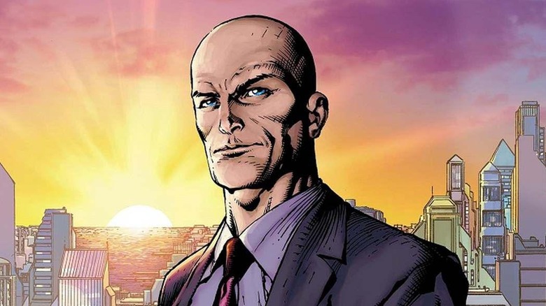 Lex Luthor stands in front of the Metropolis skyline as the sun sets