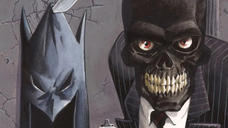 Black Mask stands next to the mask of Batman