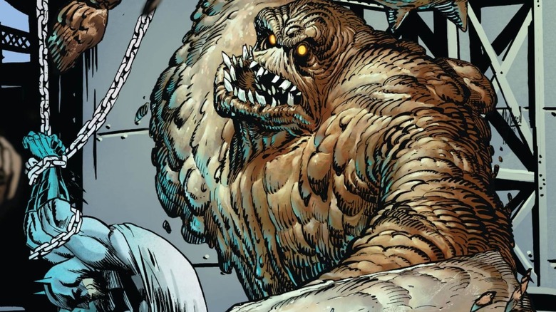 Clayface looming over Batman