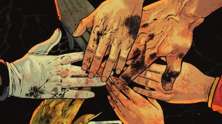 Absolute Evil cover showing the Justice League putting their hands together in circle