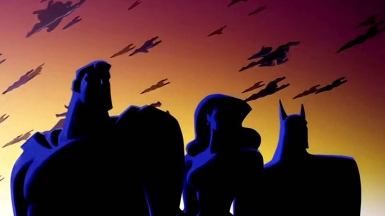 Justice League Unlimited intro showing Superman, Wonder Woman, and Batman standing together in shadow as other superheroes fly over