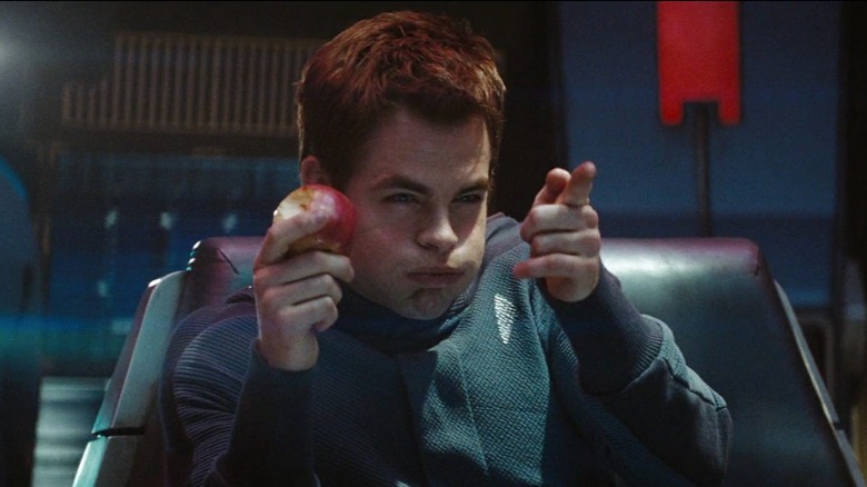 Star Trek (2009) - James Kirk (Chris Pine) eating apple, puffing his cheeks and making finger gun during Kobayshi Maru test