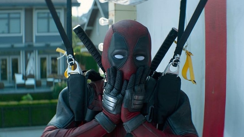 Ryan Reynolds in the role of Deadpool with his hands off his mouth in a shock in Deadpool 2