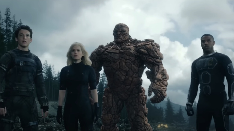 Miles Teller's Reed Richards, Kate Mara's Sue Storm, Michael B. Jordan's Johnny Storm, and Jamie Bell's Ben Grimm stand side by side in Fantastic Four