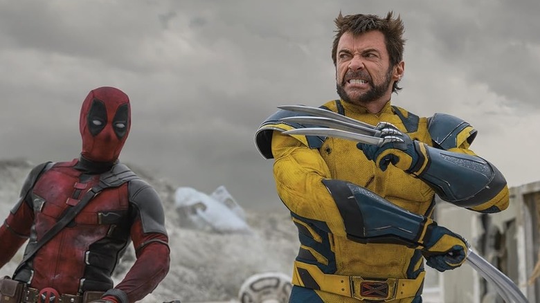 Hugh Jackman as Wolverine with his claws out with Ryan Reynolds as Deadpool behind him in Deadpool & Wolverine