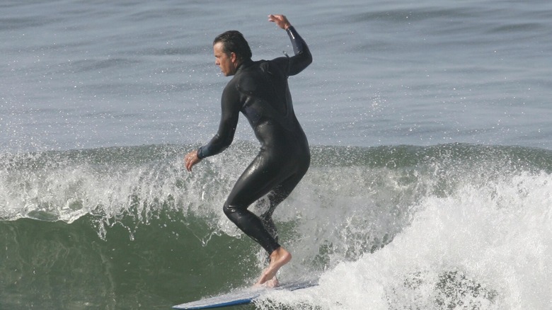 A surfer catching a wave in John from Cincinnati