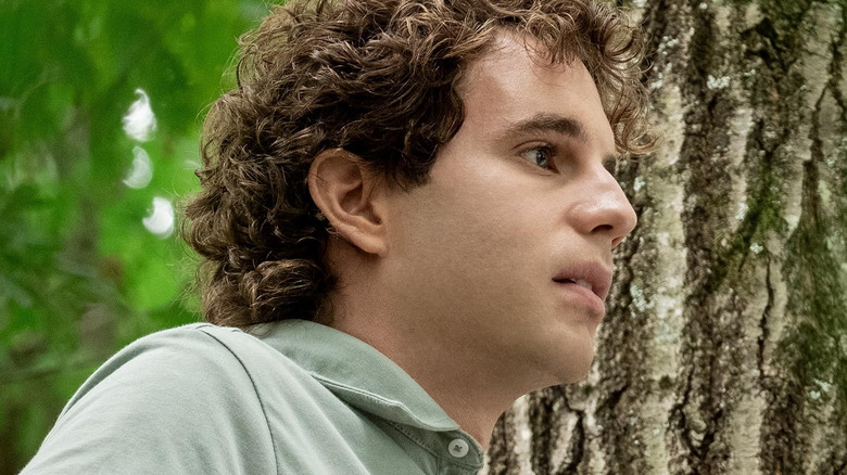 Ben Platt as Evan Hansen standing next to a tree in Dear Evan Hansen